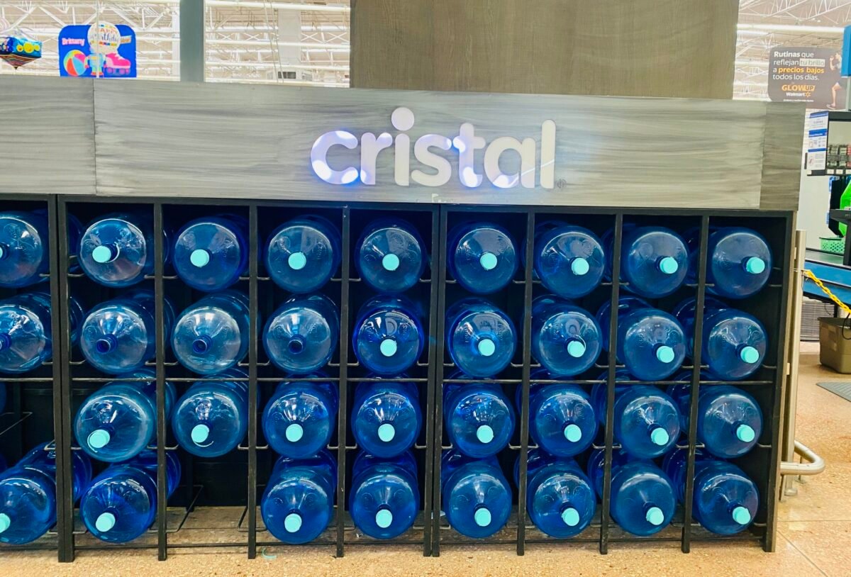 Cristal brand 20-liter water garrafones stacked in display at Walmart in Mérida, Yucatán