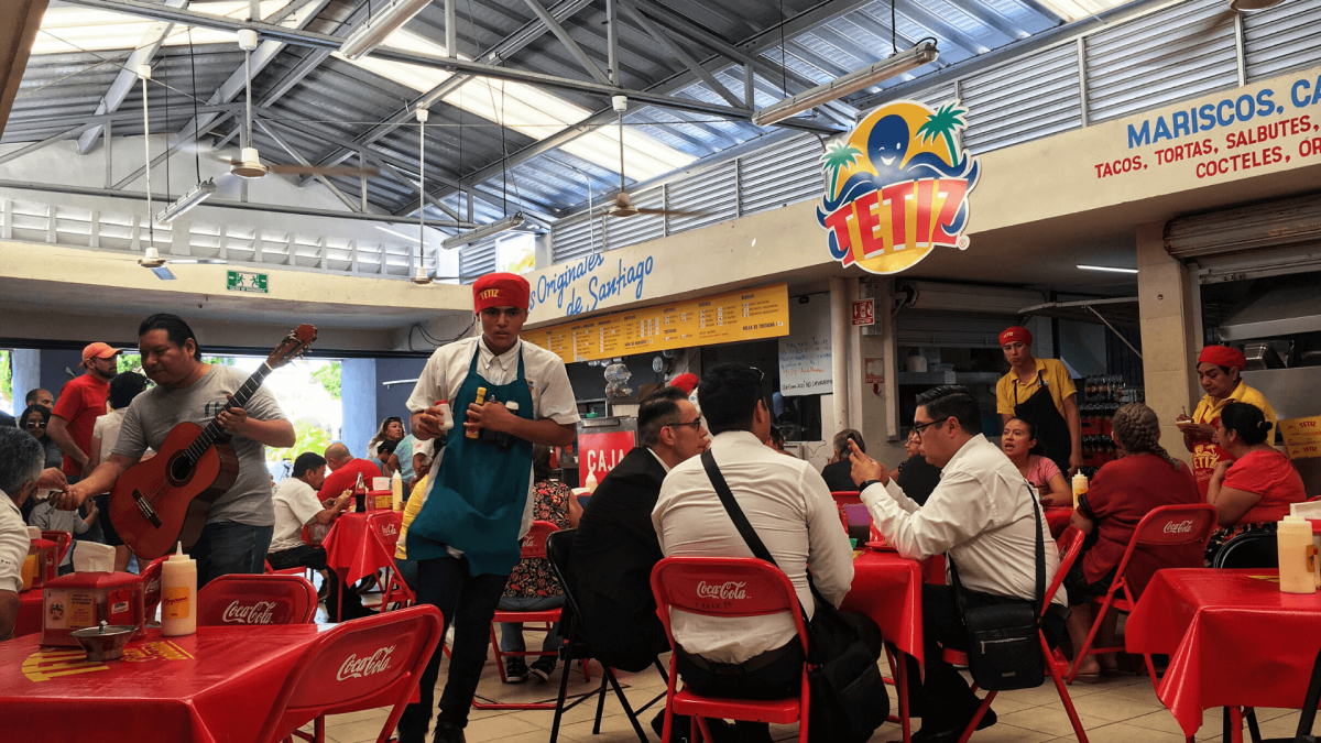waiter waiting tables in santiago market restaurant