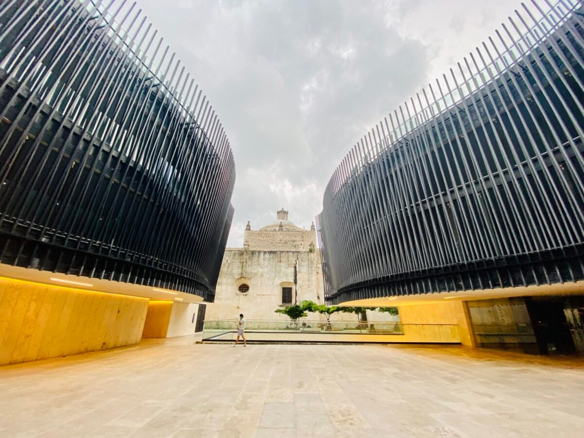 Palacio de Música in Mérida, Mexico — modern architecture framing a historic colonial church in Centro