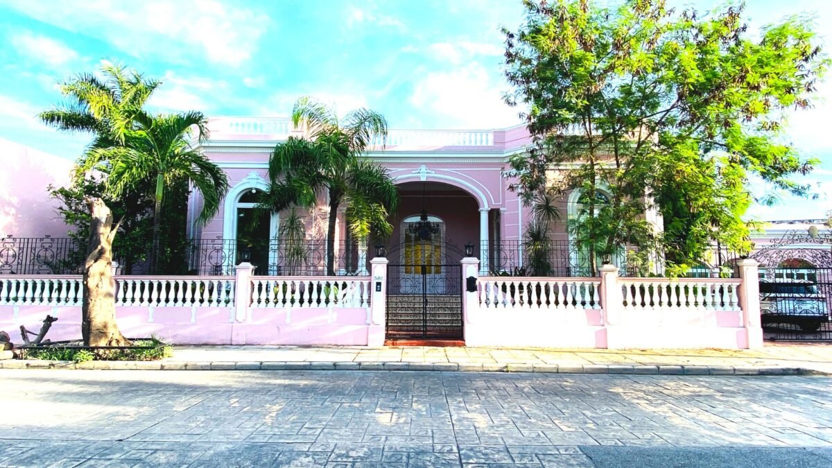 Pink colonial house with trees on Calle 59 in Centro Merida Mexico