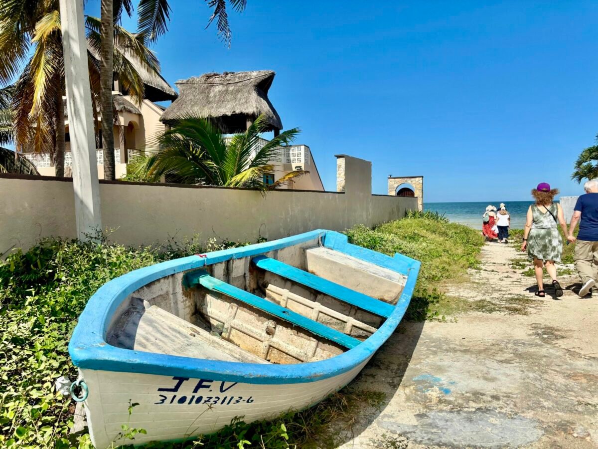Blue and white boat on the beach in Chelem Yucatan Mexico