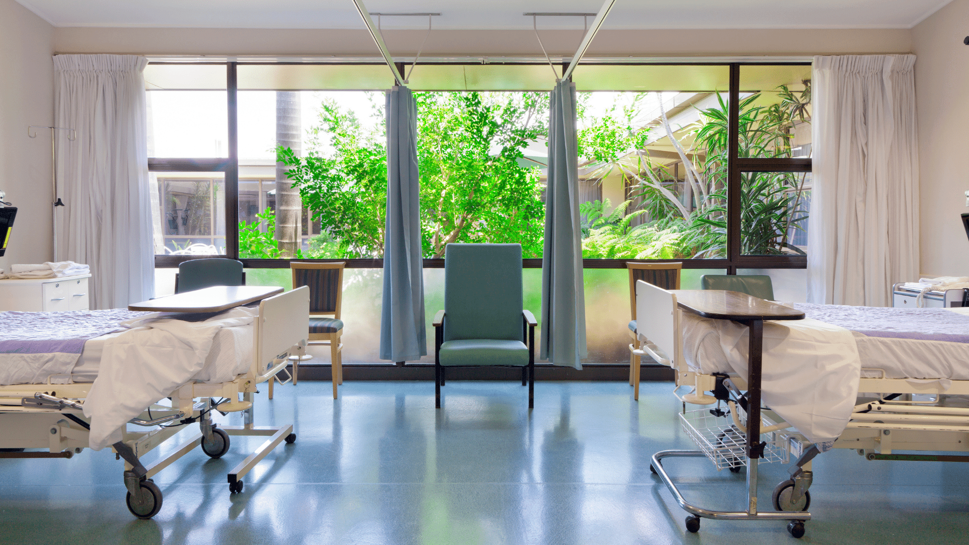 hospital recovery room overlooking a lush tropical landscape