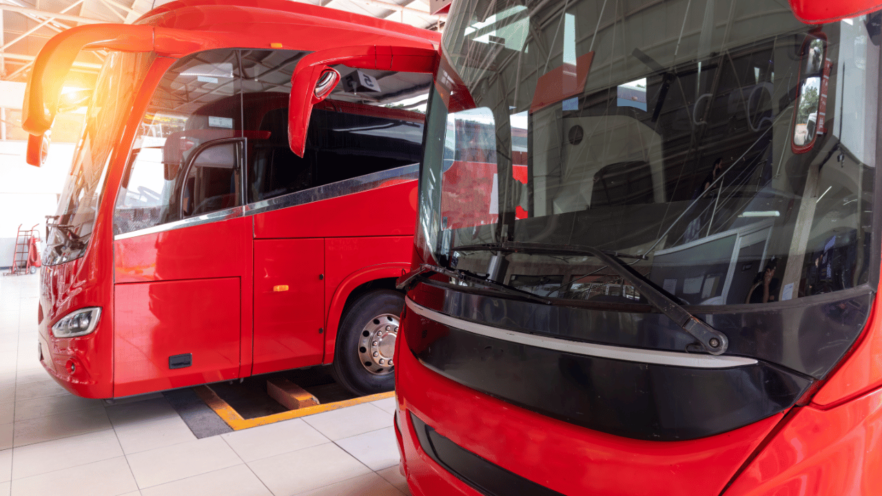 2 red ADO busses in the Merida to Cancun station