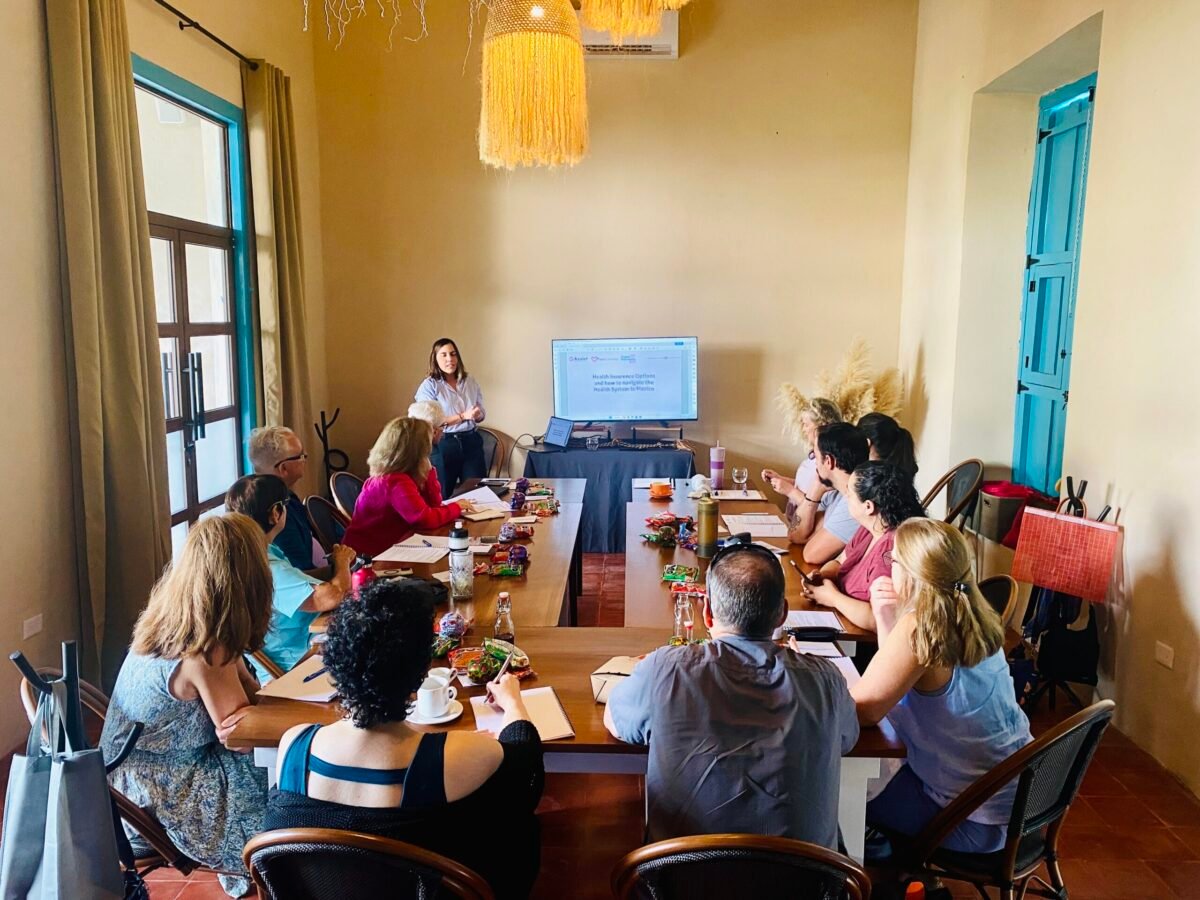 Expatsi scouting trip presentation by Pati Sales of Expat Insurance speaking to a group of guests in Merida mexico