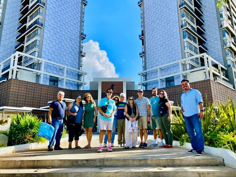 Angel Rodriguez with group scouting clients from Expatsi standing in front of high rise in Merida Mexico