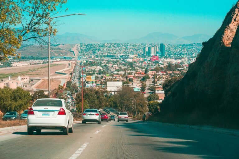 Driving down a road in Baja California with city in the background