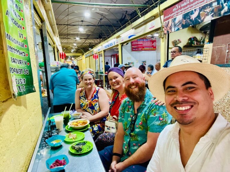 Angel Rodriguez with scouting trip clients and Amy Jones in Garcia Rejon Market in Merida Mexico